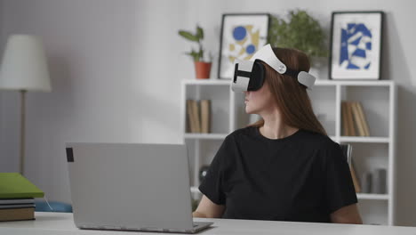 woman-is-watching-around-using-modern-head-mounted-display-for-vr-in-living-room-medium-portrait-of-female-user-indoors-device-for-video-games-and-education